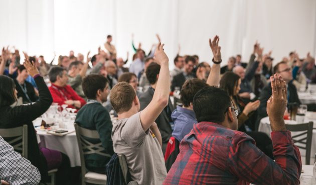 crowd participating at speaking event